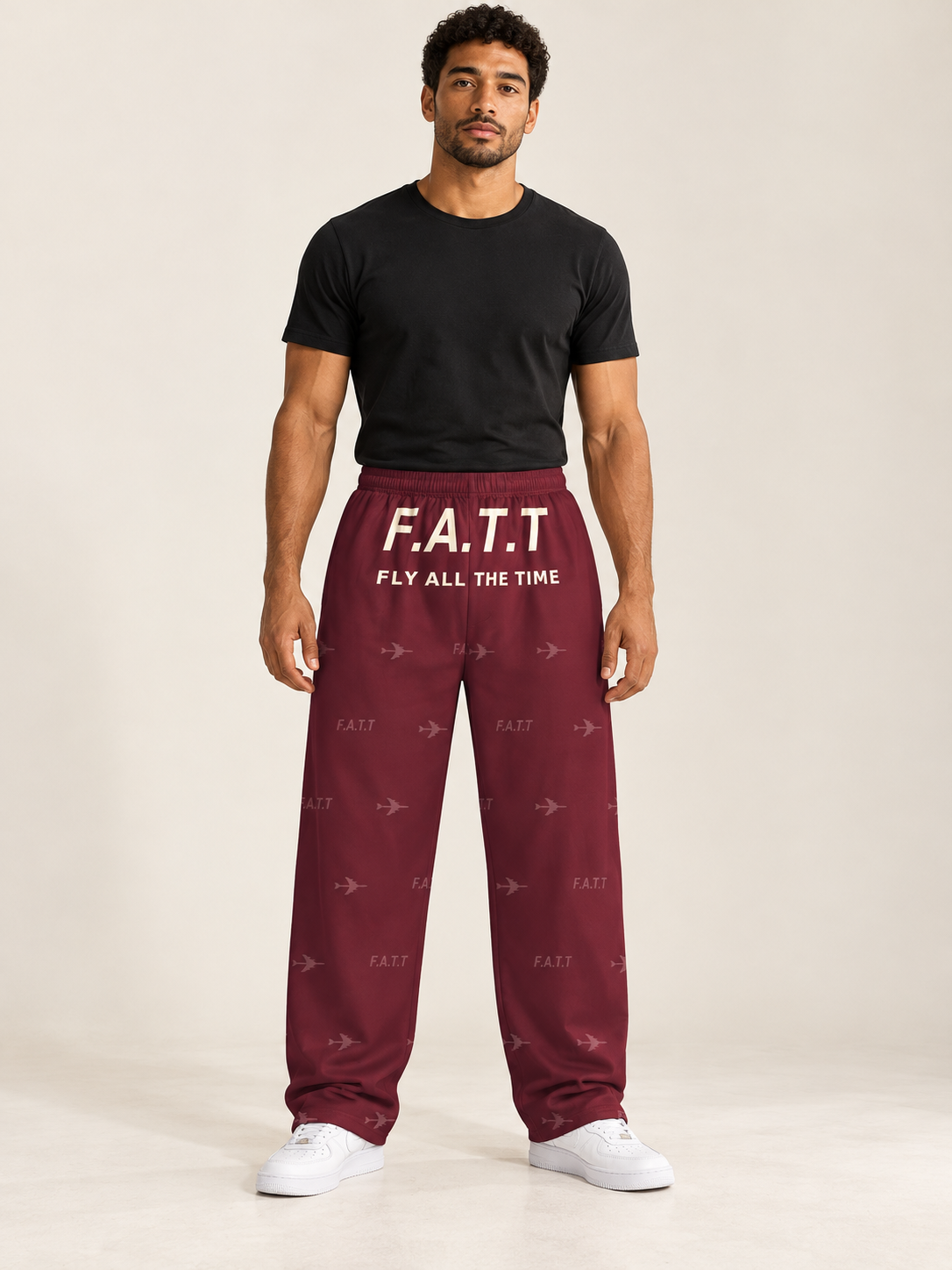 AI styling mockup — F.A.T.T Men's Flight Lounge Pants — Burgundy / Cream on an adult model. See product photos for garment details.