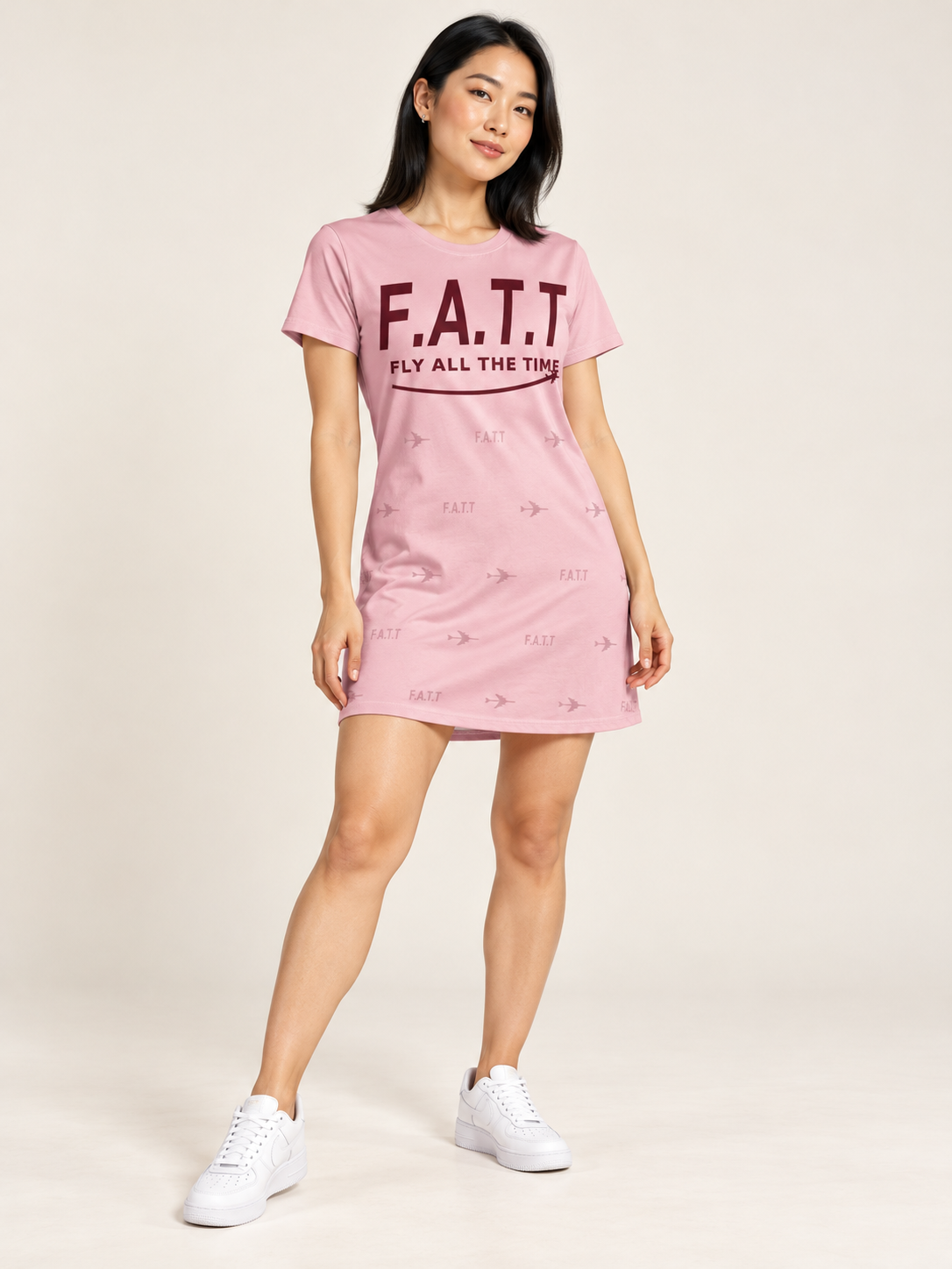 AI styling mockup — F.A.T.T Women's Flight T-Shirt Dress — Blush / Burgundy on an adult model. See product photos for garment details.